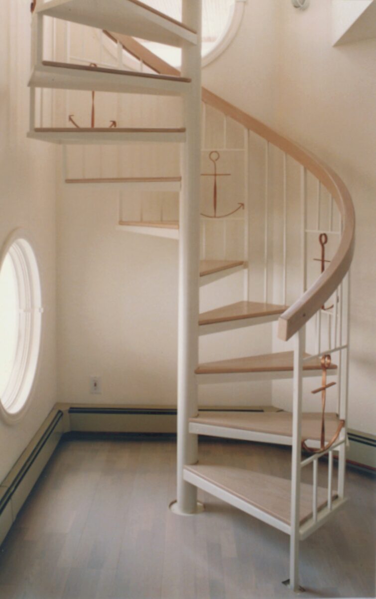 White Steel Spiral Stair with Wood Handrail and Decorative Baluster Inserts